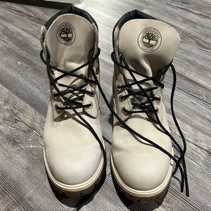 White/Cream Timberland Boots with black laces and gold accents.